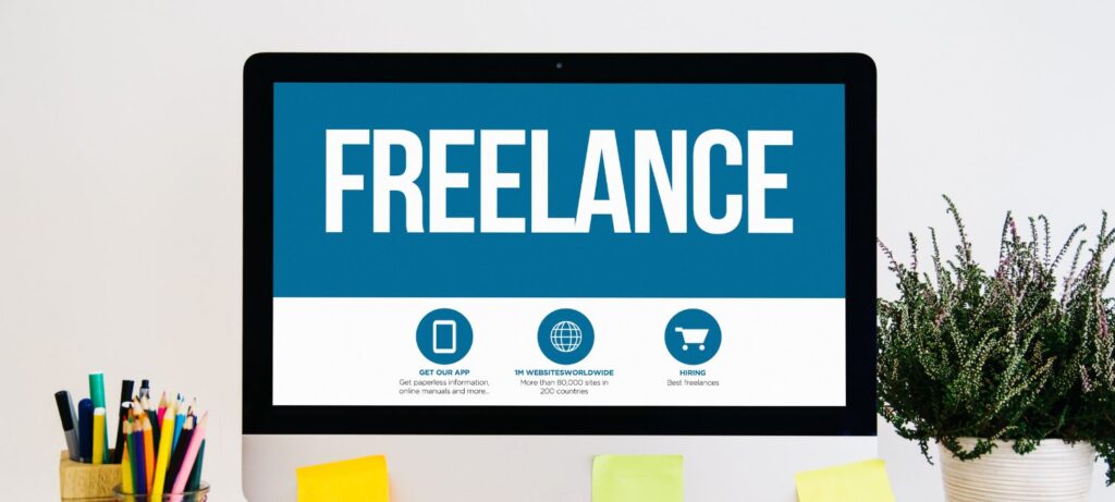  A web page with a blue background displays the word 'Freelance' in large text at the top. Below this are four icons with text that reads 'Get Our App', '1M Websites Worldwide', and 'Hiring'. To the right of these icons is a potted plant.